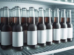 Cola bottles with blank white labels on freezer shelf