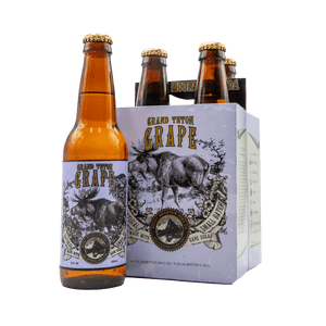 Brown bottle of Grand Teton Grape soda pictured beside four-pack with moose illustration on lavender packaging
