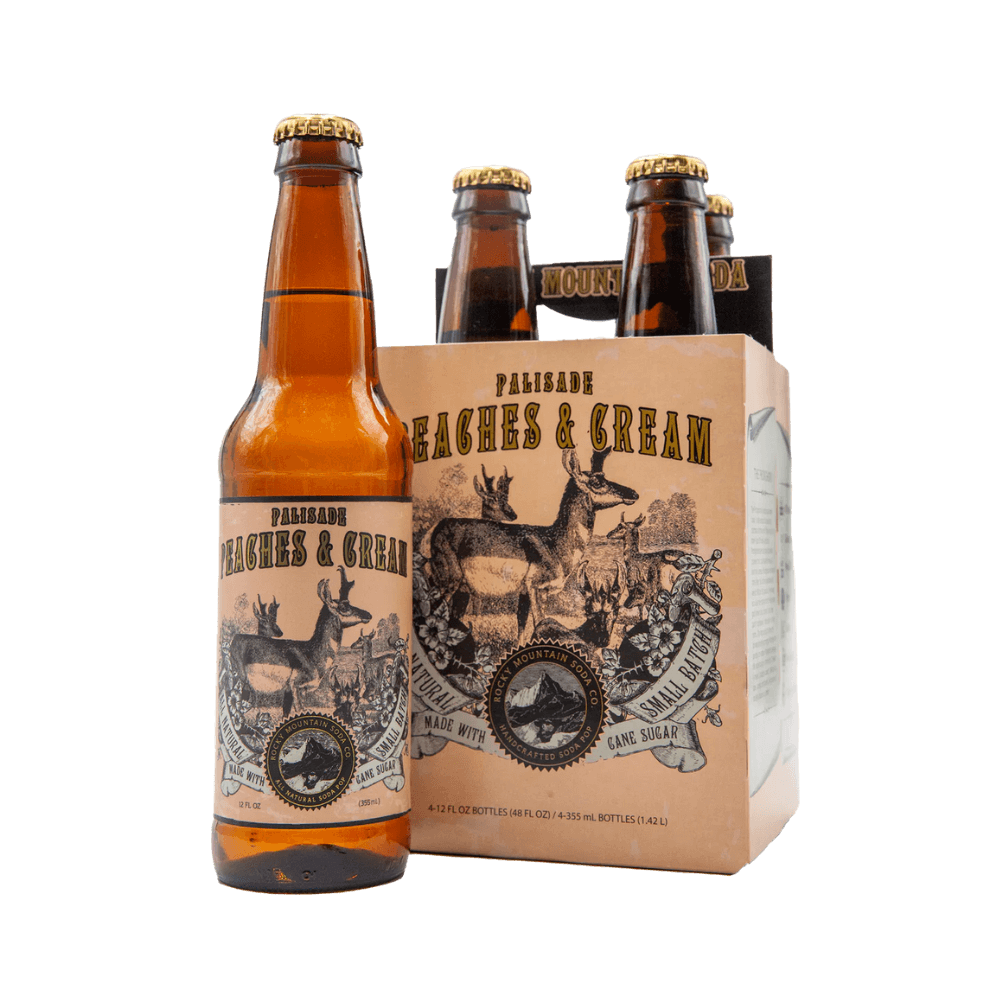 Brown bottle of Palisade Peaches and Cream soda with deer illustrations on label pictured beside four-pack